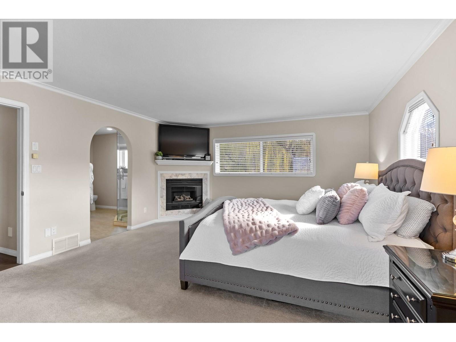 7115 Tronson Road, Vernon, BC - Indoor Photo Showing Bedroom With Fireplace