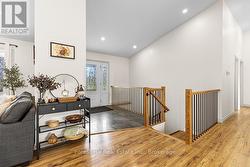 Foyer opens to living area and stairs to LL -