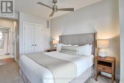 full closet and king bed with lake views -