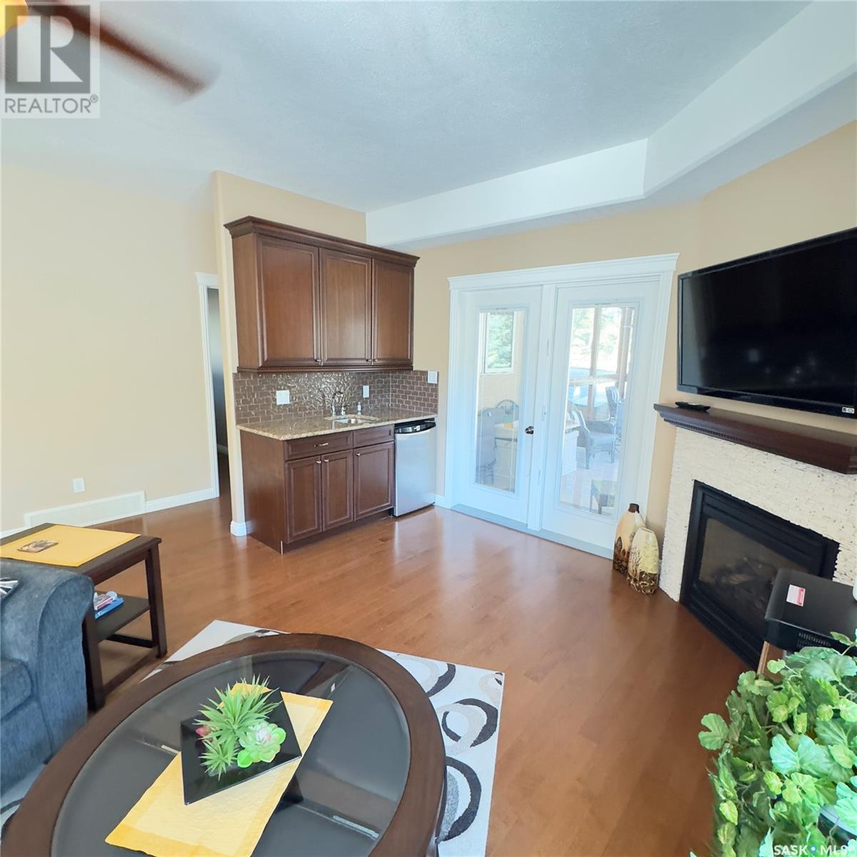 82 Estates Drive, Elk Ridge, SK - Indoor Photo Showing Living Room With Fireplace