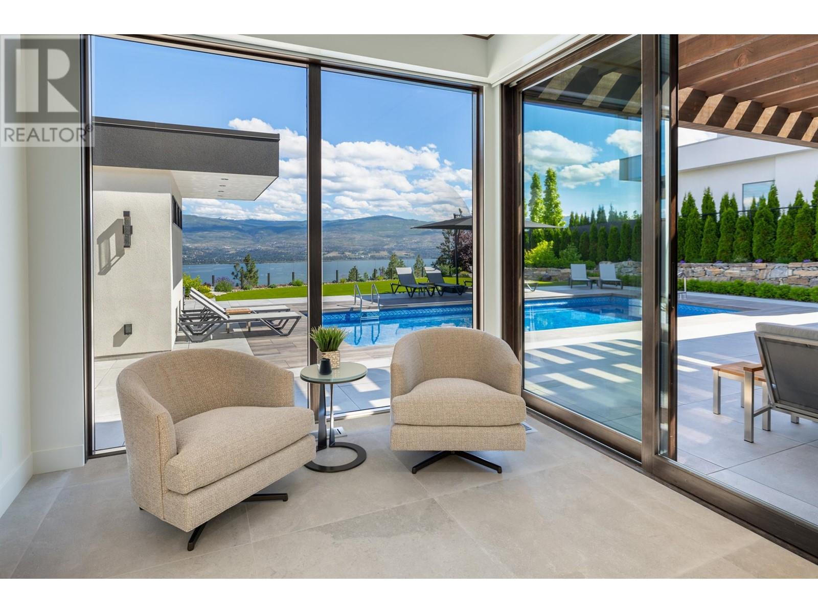 Sunny sitting area in primary bedroom - 2463 Thacker Drive, West Kelowna, BC - Indoor With In Ground Pool