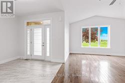 Foyer with tile & 9 ft ceiling/Living with hrwd -