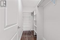 Primary Bedroom Walk-In Closet-hrwd floor -