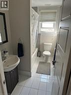 Full bath with tile patterned floors, shower / tub combo with curtain, and vanity -