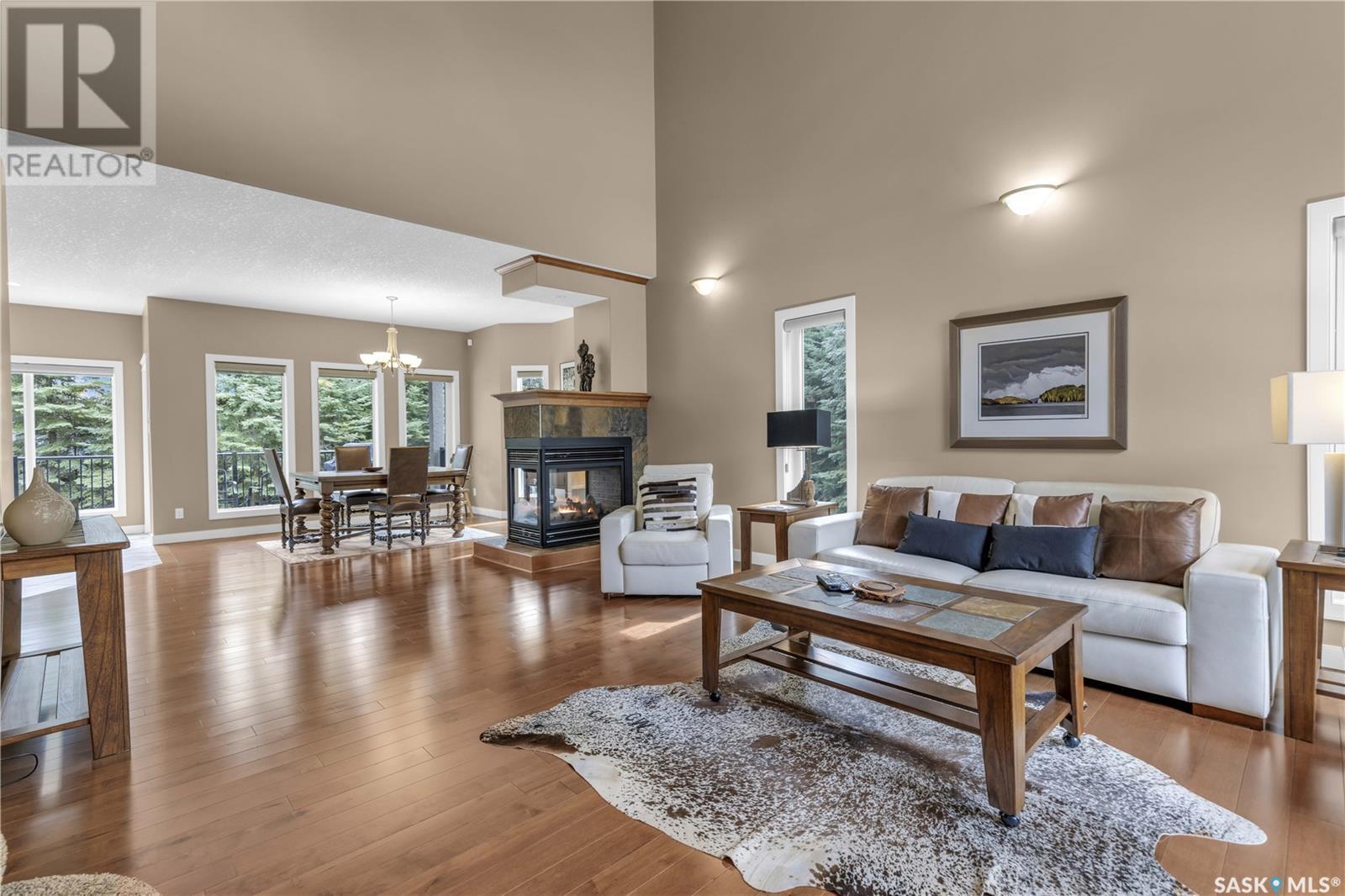 Estates Drive, Elk Ridge, SK - Indoor Photo Showing Living Room With Fireplace