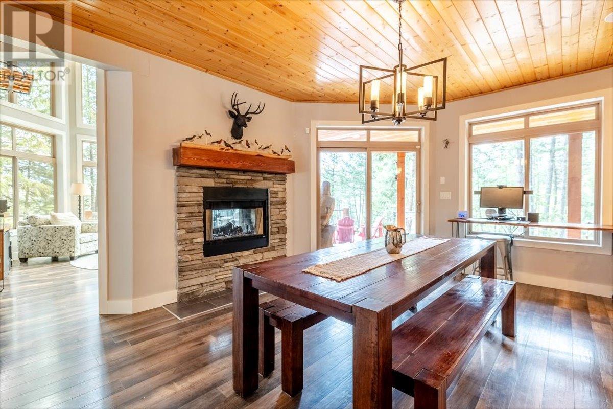 9942 Osprey Landing Drive, Wardner, BC - Indoor Photo Showing Dining Room With Fireplace