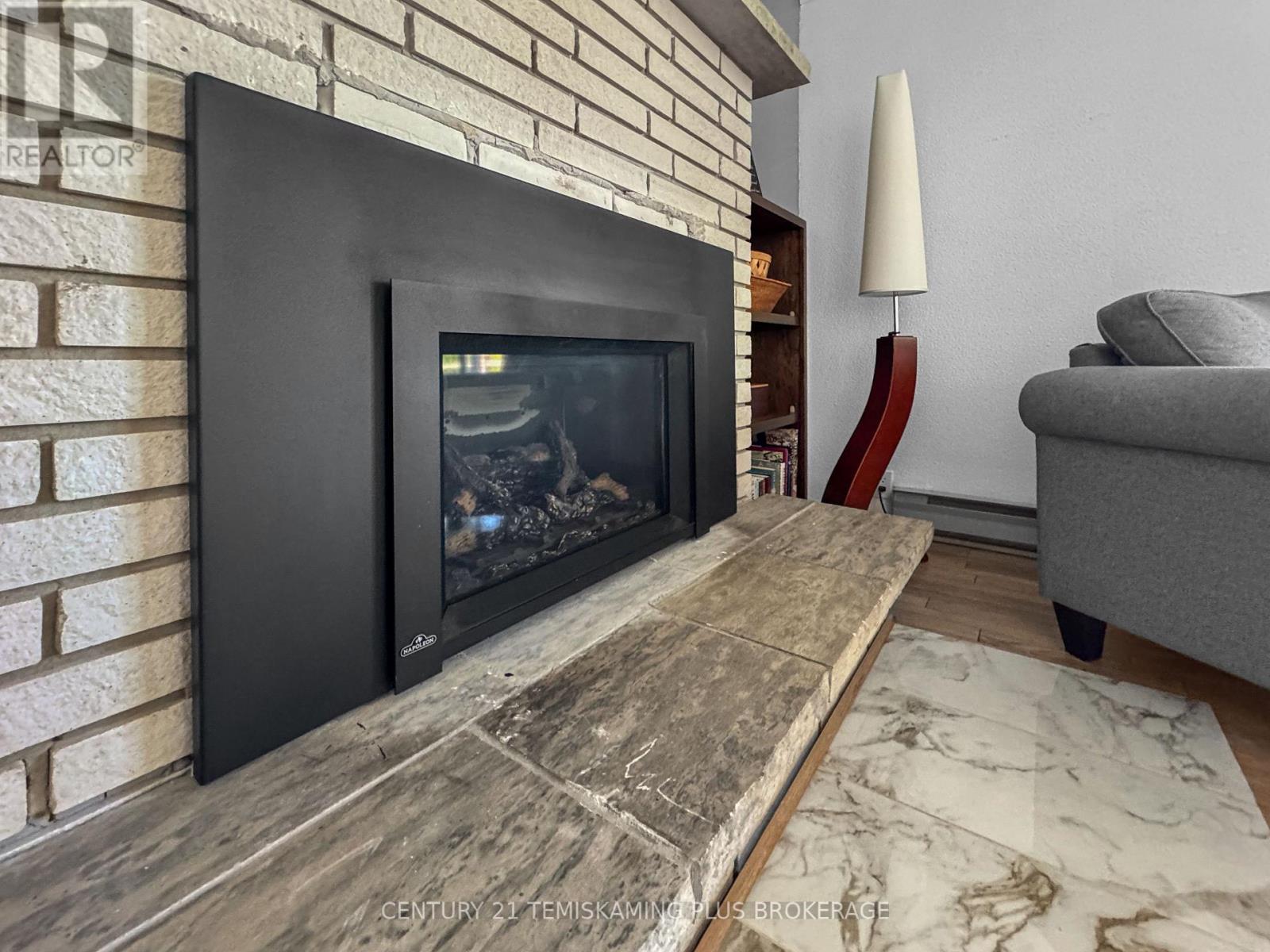 501178 Berry Road, Timiskaming (Tim - Outside - Rural), ON - Indoor Photo Showing Living Room With Fireplace
