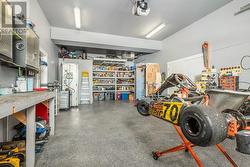 Third garage, heated, with loft area and shelving - loads of organized shelving. -