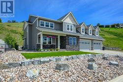 Very picturesque style home, crisp white trim, warm grey tone exterior and punch of color for a welcoming front door -