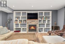 View from standing in the Kitchen (gas fireplace), built in entertainment unit -