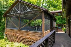 Deck leads to screened-in lounging area -