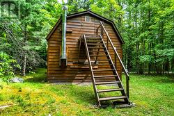 Garage-workshop steps at back up to loft -