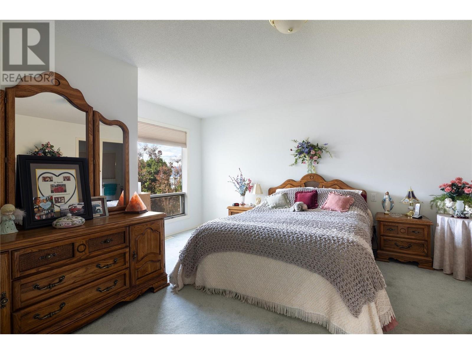 Main level Master #1 - 8827 Michael Drive, Coldstream, BC - Indoor Photo Showing Bedroom