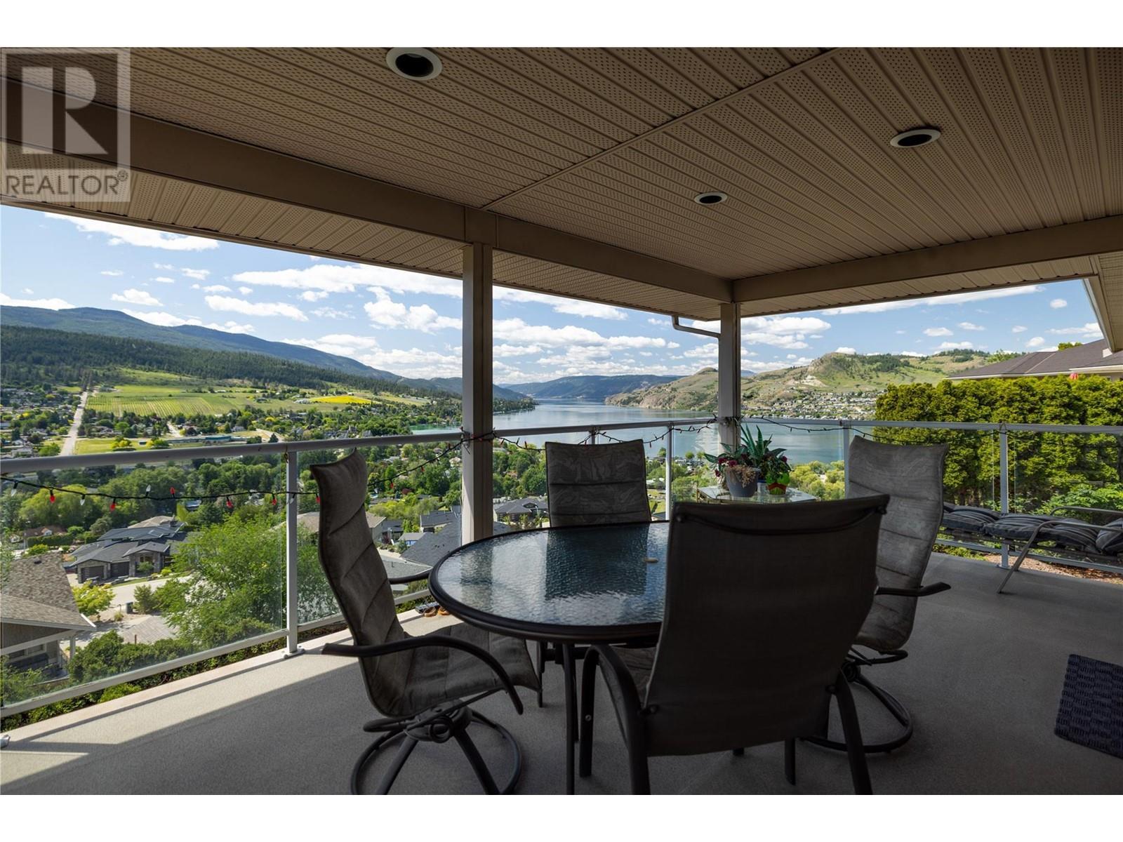 the covered deck. - 8827 Michael Drive, Coldstream, BC - Outdoor With Deck Patio Veranda With View With Exterior