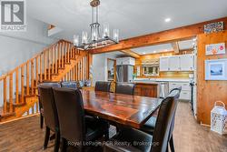 Open-concept living space with wood beams. -