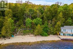 With natural stone stairs to shoreline. -