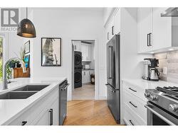 Kitchen with view into mud/laundry and 2 piece bathroom -