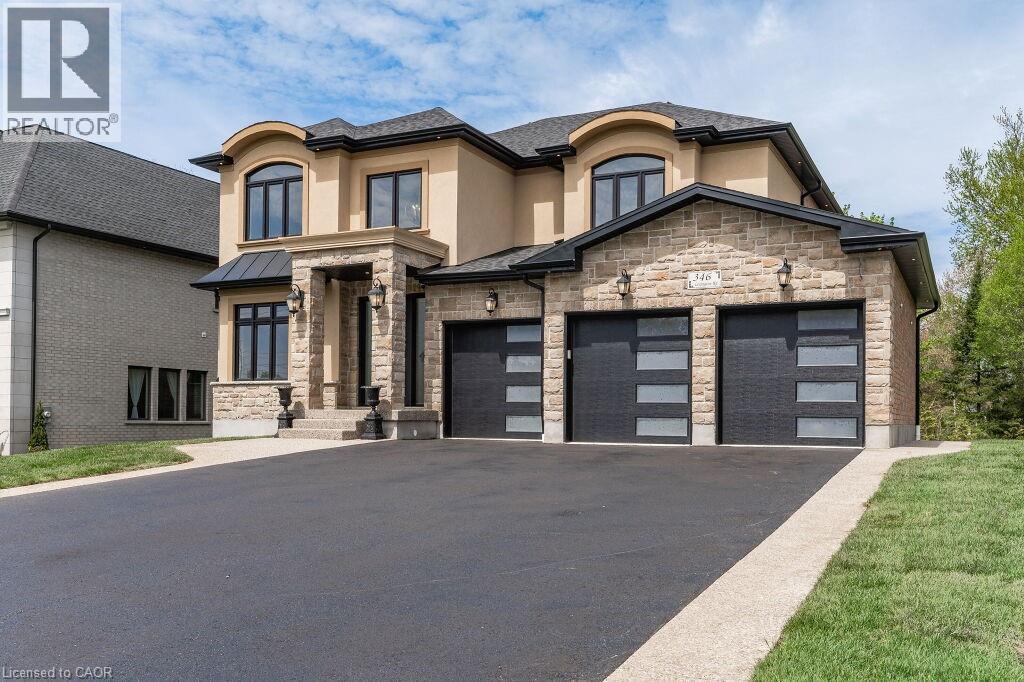 View of front of house featuring stucco siding, stone siding, and asphalt driveway - 346 Lexington Road, Waterloo, ON - Outdoor With Facade