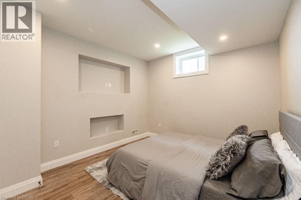 Bedroom with wood finished floors, baseboards, and recessed lighting - 346 Lexington Road, Waterloo, ON - Indoor