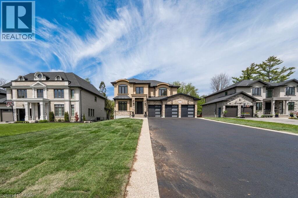 View of front of property featuring driveway, a garage, and a front yard - 346 Lexington Road, Waterloo, ON - Outdoor With Facade