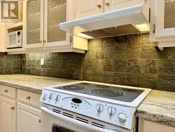 Granite surfaces, stone backsplash & built-ins. -