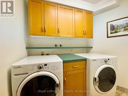 Fully finished laundry with cabinetry & counter. -