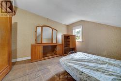 Bedroom with window overlooking backyard -