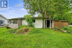 Side view of garage w/ chicken coop & sheds -