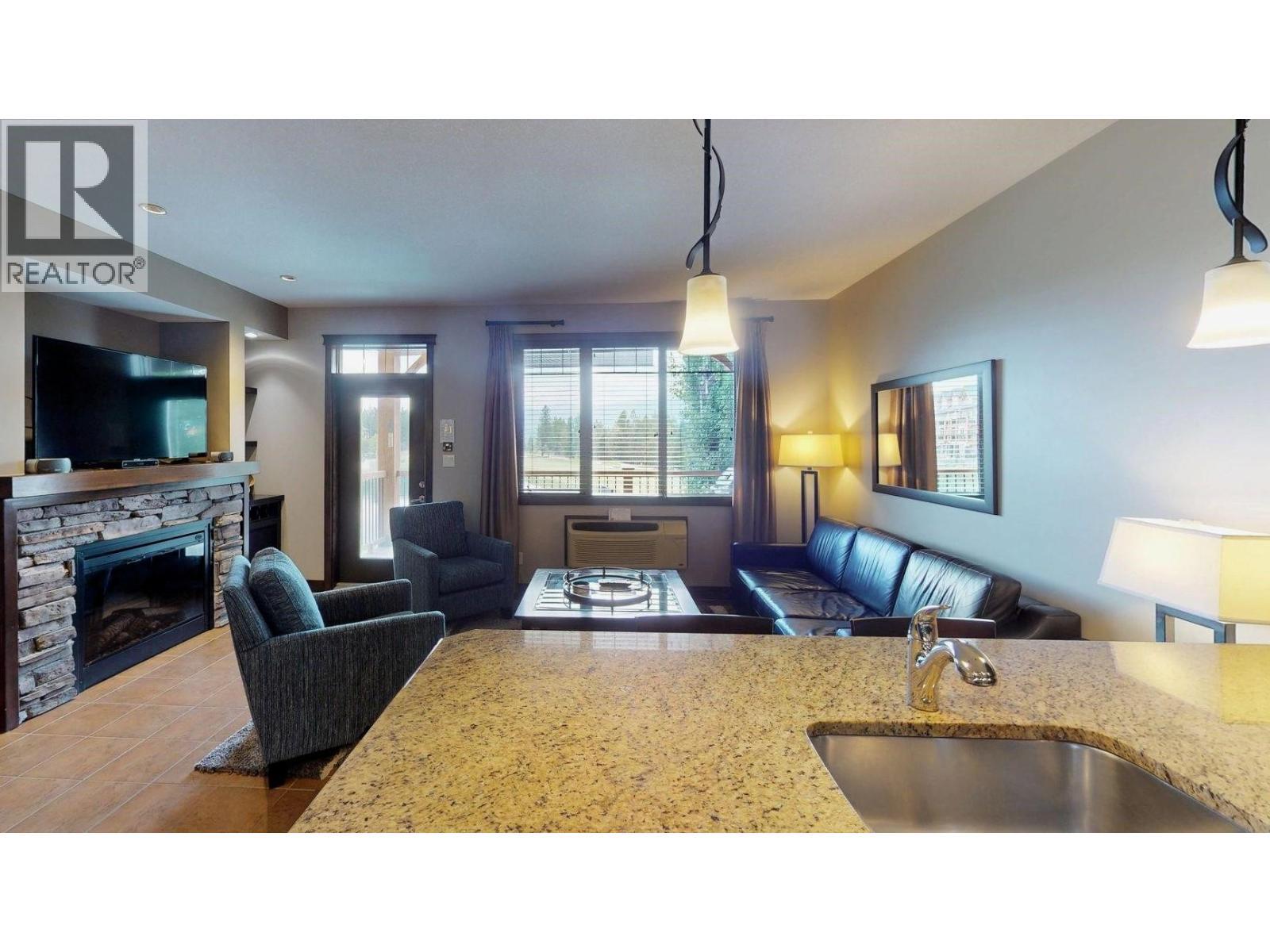 800 Bighorn Boulevard Unit# 825 E, Radium Hot Springs, BC - Indoor With Fireplace