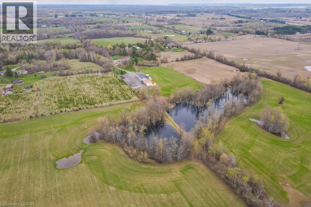Aerial view of property and surrounding area with a nearby body of water and a local golf course - 4290 Victoria Road S, Puslinch, ON - Outdoor With View