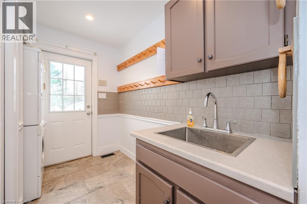 Washroom with estacked washer and dryer and recessed lighting - 4290 Victoria Road S, Puslinch, ON