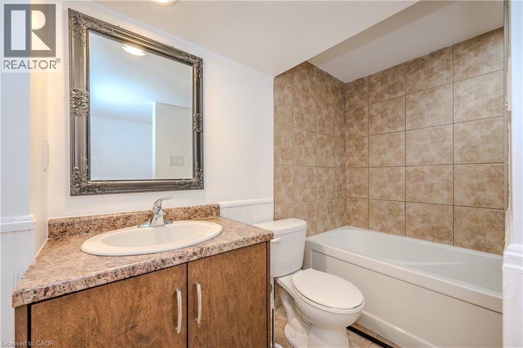 Bathroom featuring vanity, wainscoting, and shower / bathtub combination - 4290 Victoria Road S, Puslinch, ON