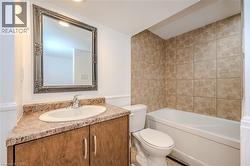 Bathroom featuring vanity, wainscoting, and shower / bathtub combination -
