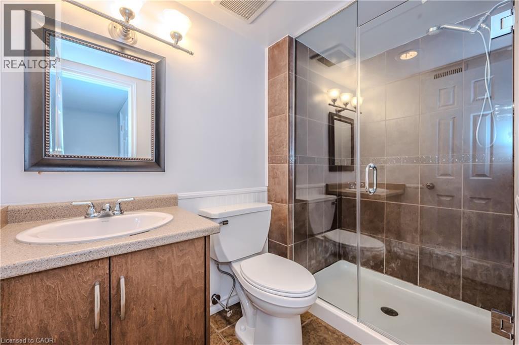 Full bathroom with a stall shower, vanity, and wainscoting - 4290 Victoria Road S, Puslinch, ON