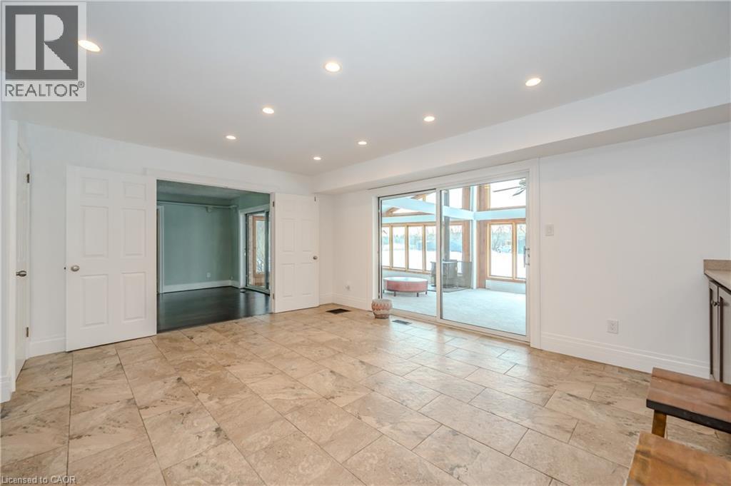 Unfurnished living room with stone tile flooring and recessed lighting - 4290 Victoria Road S, Puslinch, ON