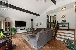 Living room with fireplace and exposed beams -