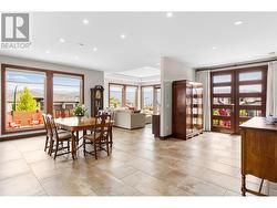 Dining room into living room with small deck off to front yard view. -