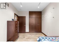 Bedroom with custom closet/cabinetry on main/upper level. -