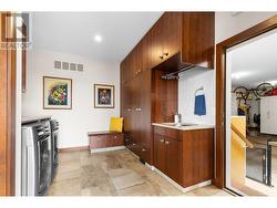 Friends and family entrance from side of home with custom cabinetry and laundry. -