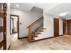 Stairs to lower level and front door entry. -