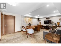 Lower level media/rec room with built in cabinets and floating shelves. -