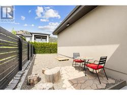 Side of house behind garage seating area. -