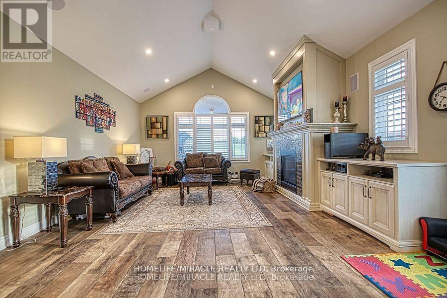 5499 Attema Crescent, West Lincoln, ON - Indoor Photo Showing Living Room With Fireplace