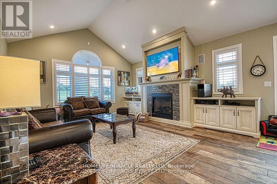 5499 Attema Crescent, West Lincoln, ON - Indoor Photo Showing Living Room With Fireplace