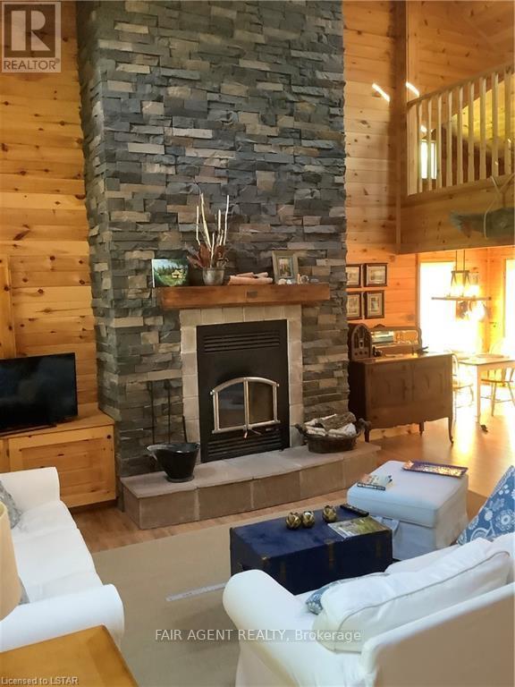 1165B Kirk Kove Road, Frontenac (Frontenac Centre), ON - Indoor Photo Showing Living Room With Fireplace