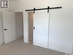 Primary bedroom bard doors to ensuite -