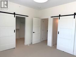 Primary bedroom barn doors to walkin closet and ensuite -