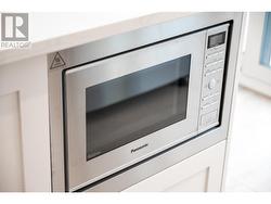 Home includes Stainless steel Panasonic Microwave in kitchen island. Island seating for 4 people. -