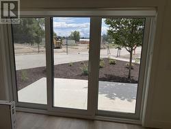 Patio with sliding doors off of den. Patio will have black metal fence with entry gate -