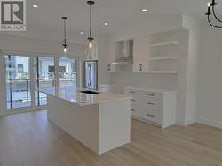 Kitchen with patio sliding doors to first of 2 patios on main level! -